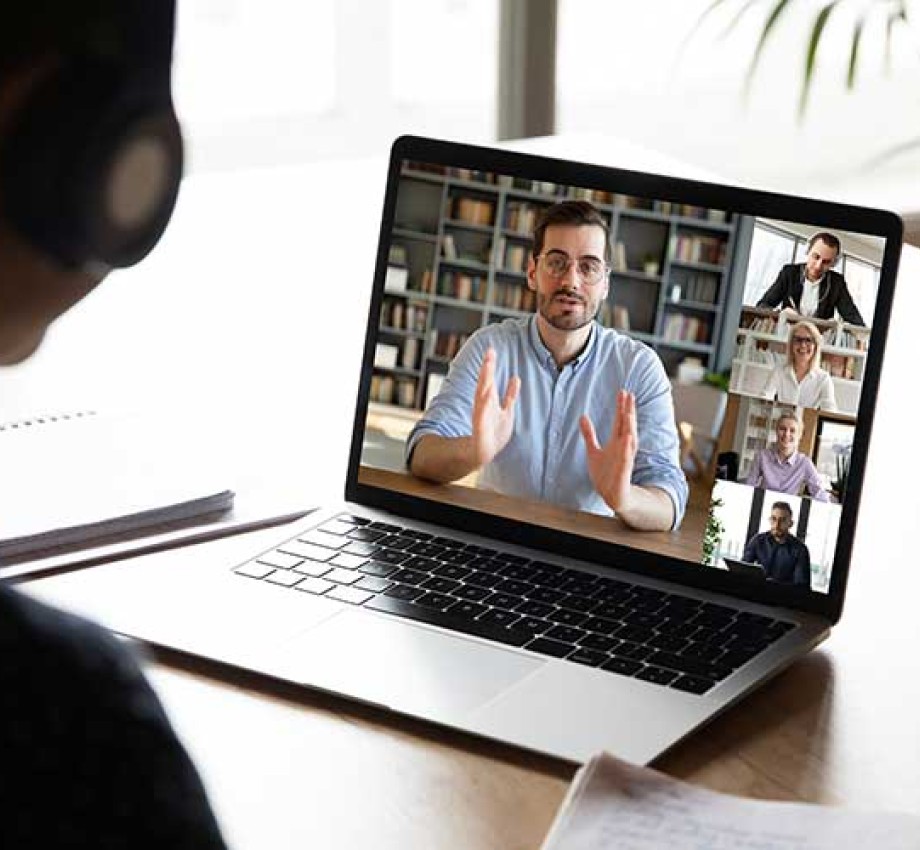 Photo of team members working on laptop through Zoom