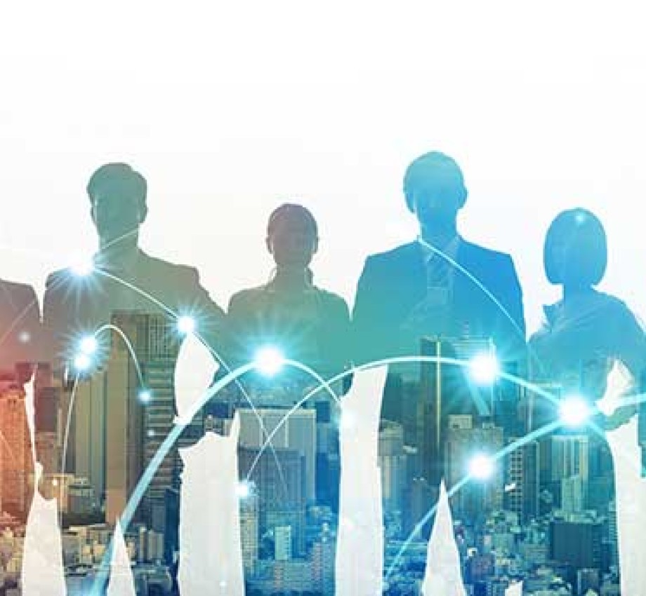 Scaled back image of multiple business people standing in front of a city skyline