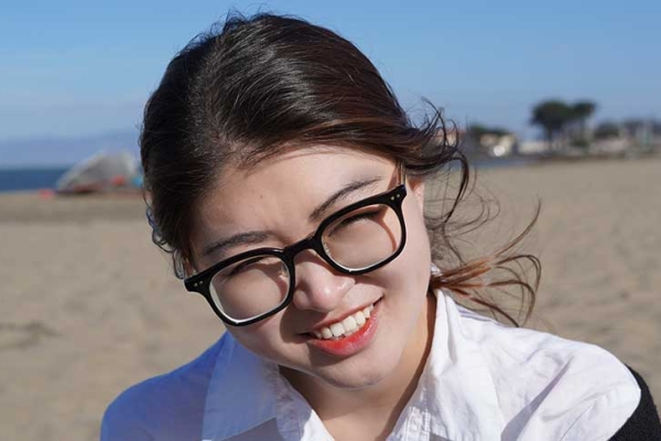 Photo of Sibble Zhang at the beach below the Golden Gate Bridge