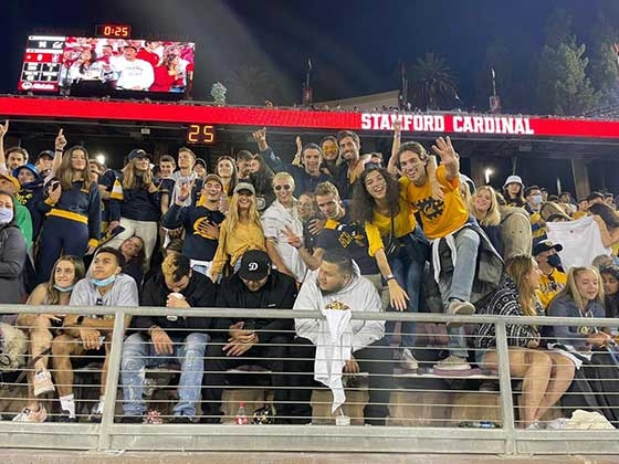 Marcelo Reis and fans in the bleachers at a UC Berkeley football game