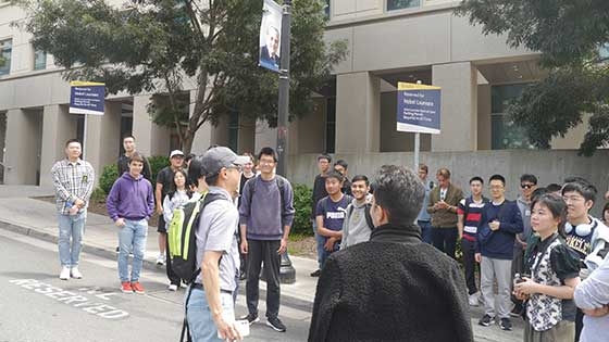 Students stand around reserved parking signs for Nobel winners