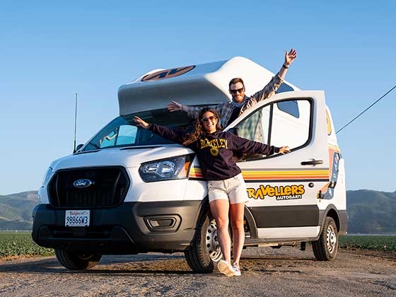 Perline Hochart and friend posing in front of RV camper while traveling