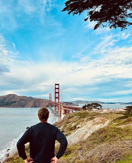 Photo of Tom Luis Huter looking upon the Golden Gate Bridge