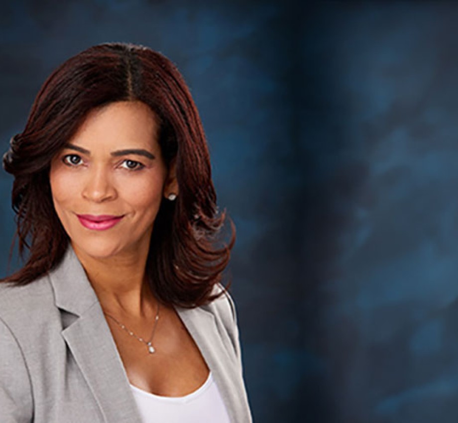 Headshot of Alis Vasquez in front of blue background