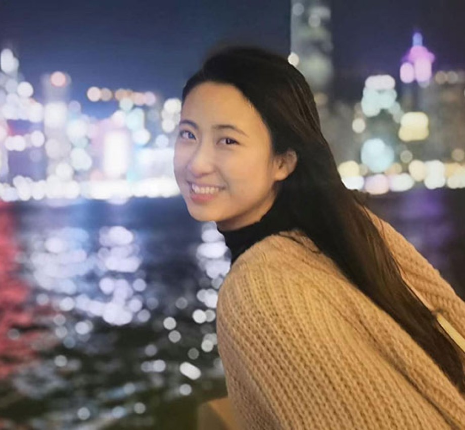 Vera Guo leaning across railing in New York City