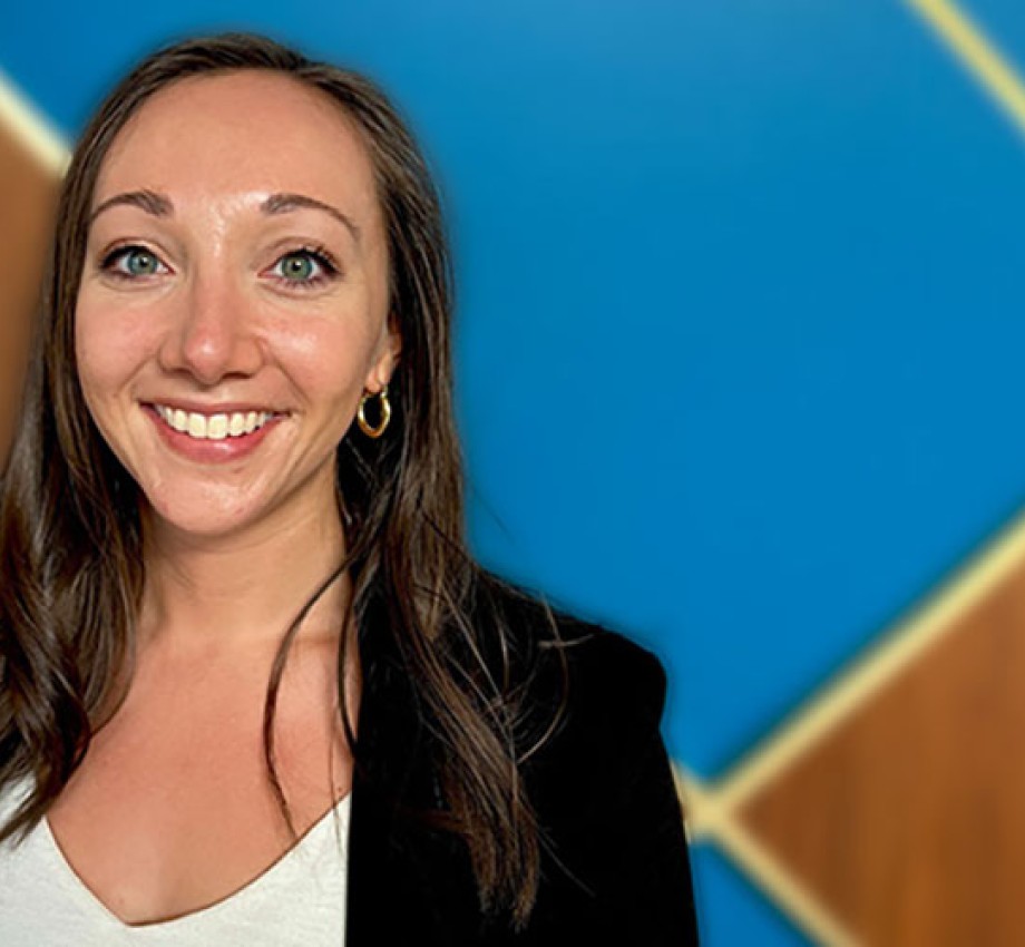 Photo of Amanda Allen in front of a blue and wood background