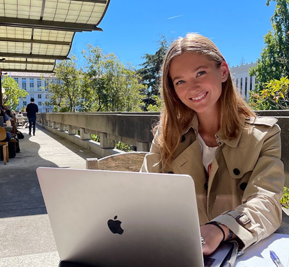 Photo of Sarah Larsen studying outside in front of a laptop