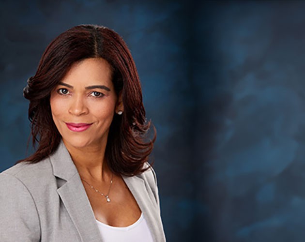 Headshot of Alis Vasquez in front of blue background