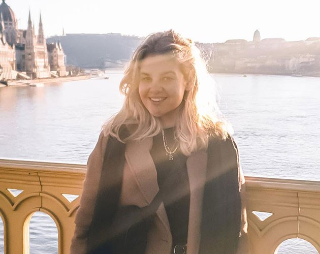 Photo of Darlien Schurmann standing on a bridge overlooking a lake