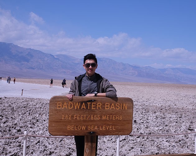 Keyang Pan stands behind a sign for Greatwater Basin