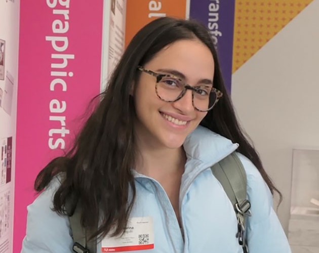 Photo of Marina Zalcberg Angulo standing in a graphic design room