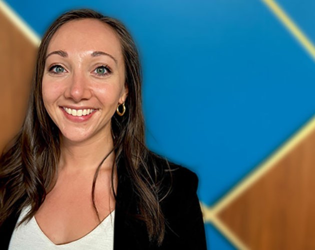 Photo of Amanda Allen in front of a blue and wood background