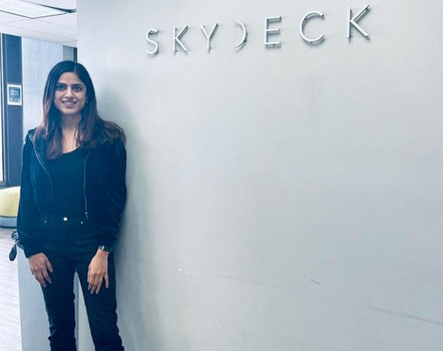 Meru Sharma standing in front of Skydeck logo