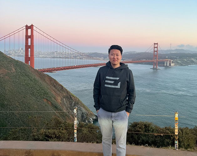 Photo of Michael Zhao in front of Golden Gate Bridge