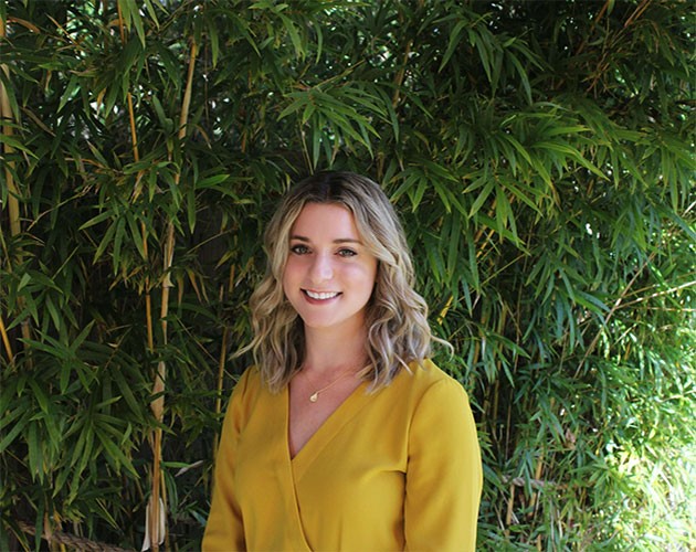 Photo of Alexis Barbalace standing in front of trees