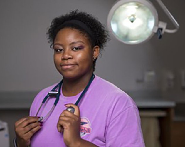 Photo of Cassandra Smith in purple medical smocks