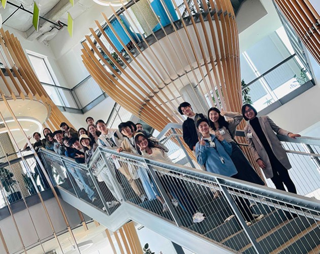 International students pose on stairs at Google 