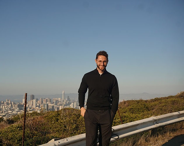 Niko Hems standing in front of San Francisco cityscape