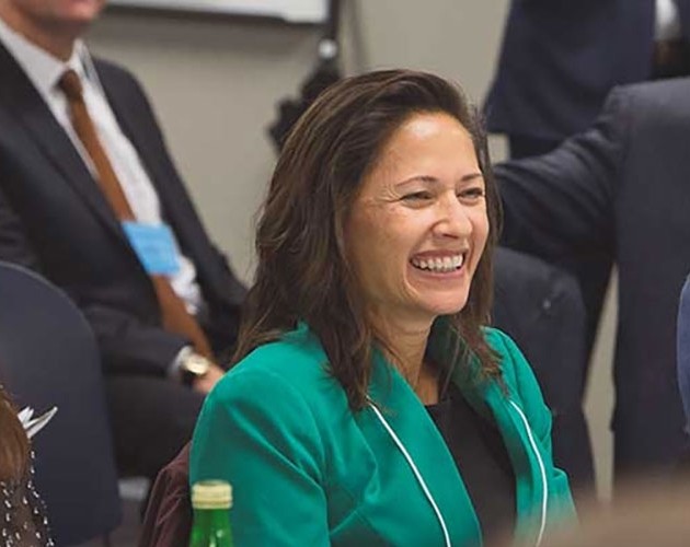 Image of woman smiling while attending an in-person event