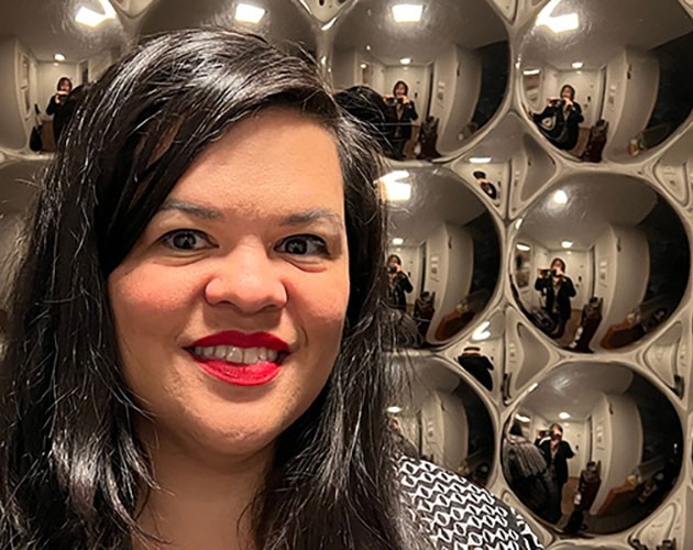 Headshot of Shannon MIlar in front of glass wall