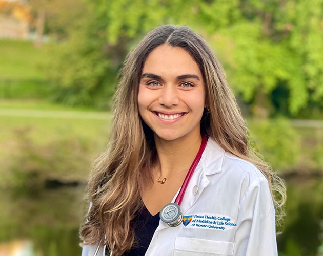 Alexandra Groome in white coat, Post-Baccalaureate Health Professions Program alumna