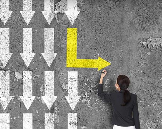 Woman painting an arrow going to the right with other arrows pointing downward