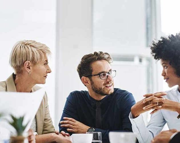 Photo of diverse group of professionals sitting at a table