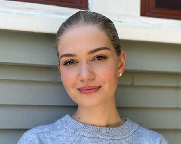 Photo of Greta Puschmann standing outside of a house