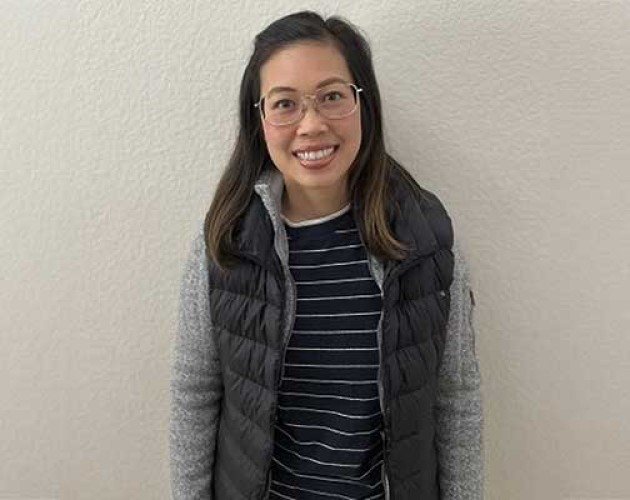 Vivian Dao Tong standing in front of white plastered wall