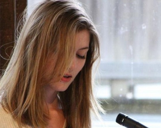 Professional Writing Community Impact Scholarship winner Adelle Brunstad reading her work at an event. Photo.