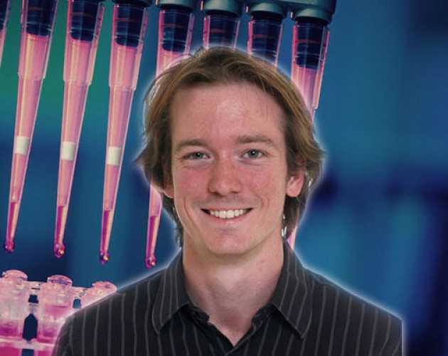 Post-Baccalaureate Health Professions Program alum Alexander Craig with lab stock photo background