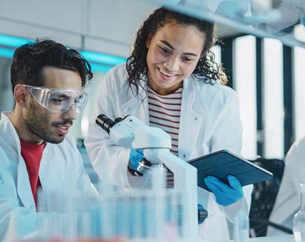 Diverse students working at a lab with microscopes