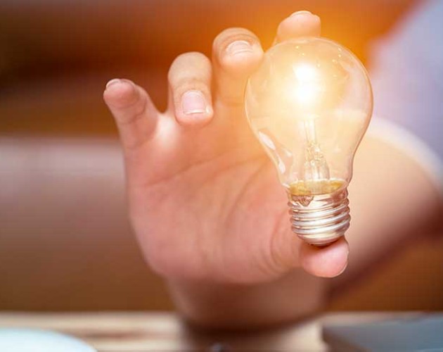 image of hand holding a lightbulb