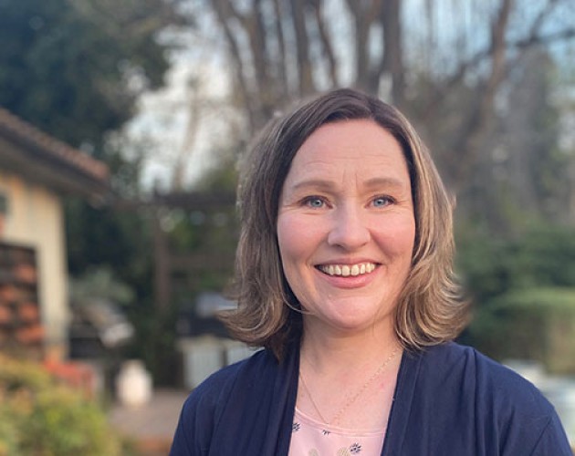 Professional Program in Child and Adolescent Treatment graduate Erin Richerson standing outside her home in California