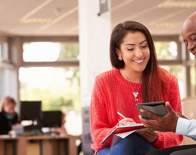 Photo of black college admissions adviser working with LatinX high school student