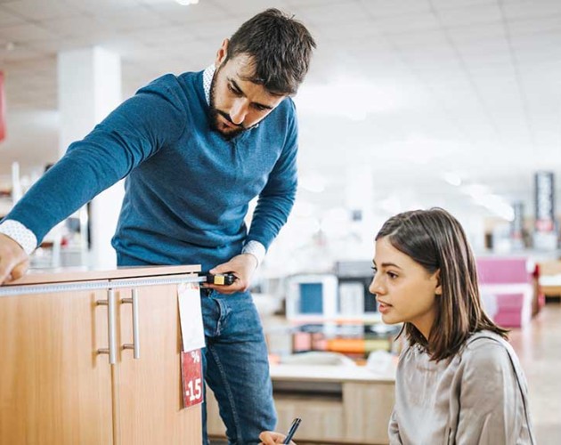 Photo of a couple shopping for school furniture