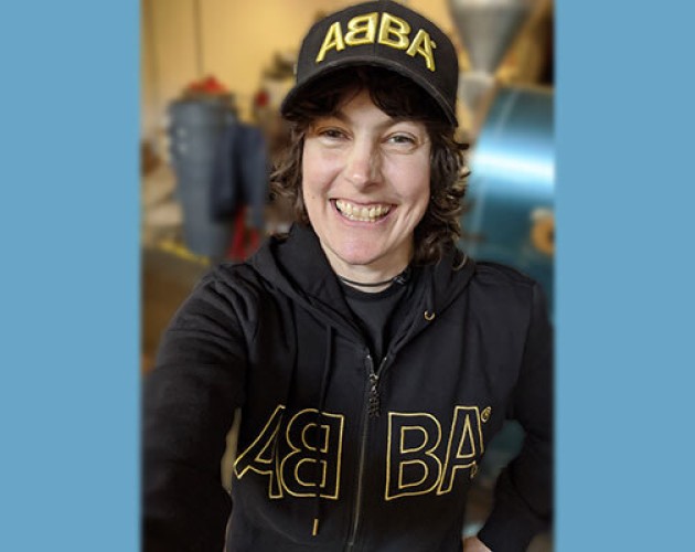 Photo of Jen St. Hilaire wearing ABBA sweatshirt and hat