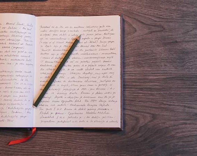 Closeup photo of a diary and pencil