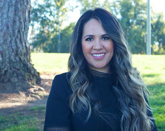 Kenia Macias standing outside in front of a tree