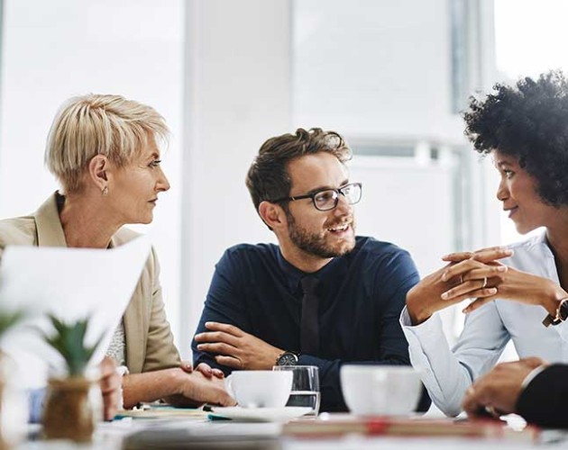 Photo of diverse group of professionals sitting at a table