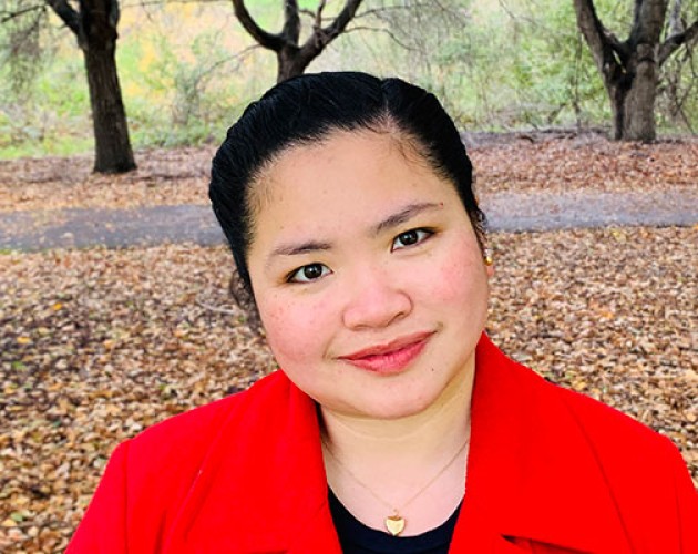 Project Management certificate graduate Laurice Gonzales outside under autumn trees