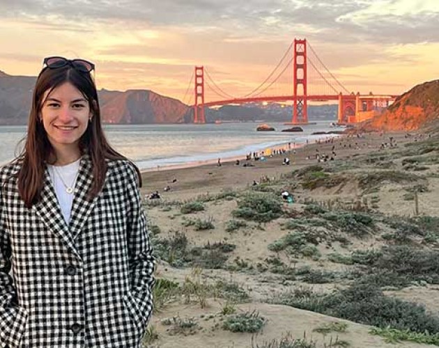 Photo of Lea Muller on a beach with Golden Gate Bridge in the background