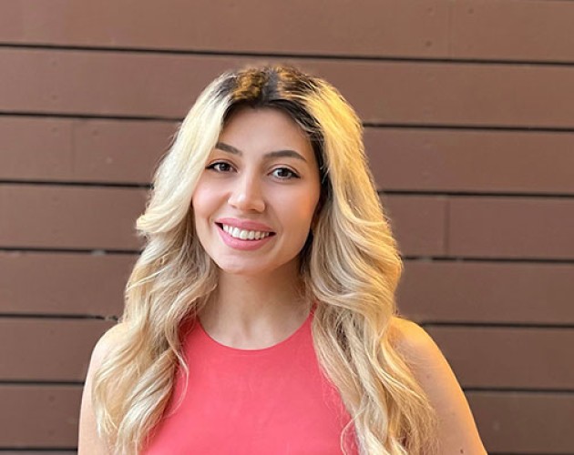 Certificate Program in Marketing graduate Marine Danielyan in front of painted brown wall