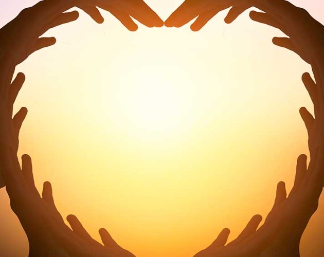 Illustration of hands joined together to shape a heart with sun in background