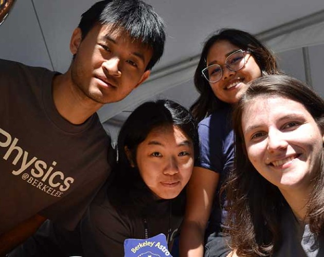 Group of physics students staring into a camera