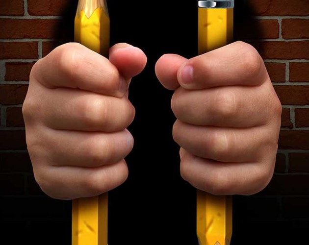 Photo of person in jail with pencils as the jail bars