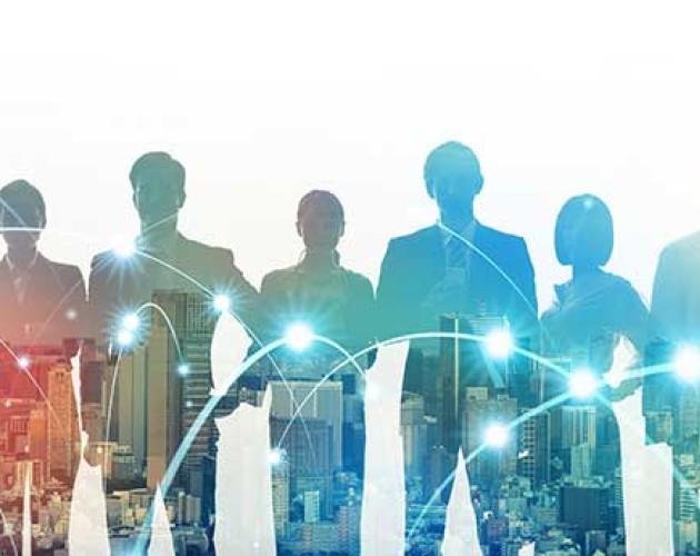 Scaled back image of multiple business people standing in front of a city skyline