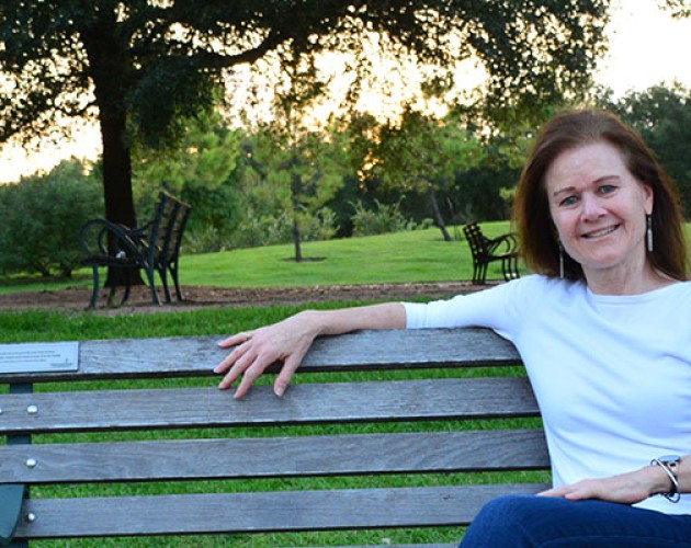 Editing program graduate Stephanie Martch sitting on a park bench in Texas