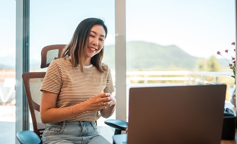 Young Chinese woman talking to coach on a laptop 