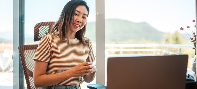 Young Chinese woman talking to coach on a laptop 